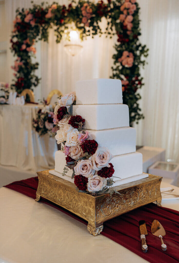 Bakersfield wedding cake featuring fondant and flowers in fall colors at luxury indoor wedding venue 