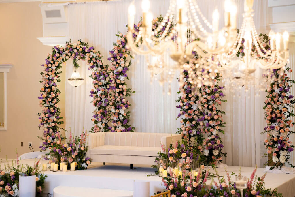 indoor Reception hall in Bakersfield for Indian weddings featuring stage decor in pinks and lilac for a luxury wedding