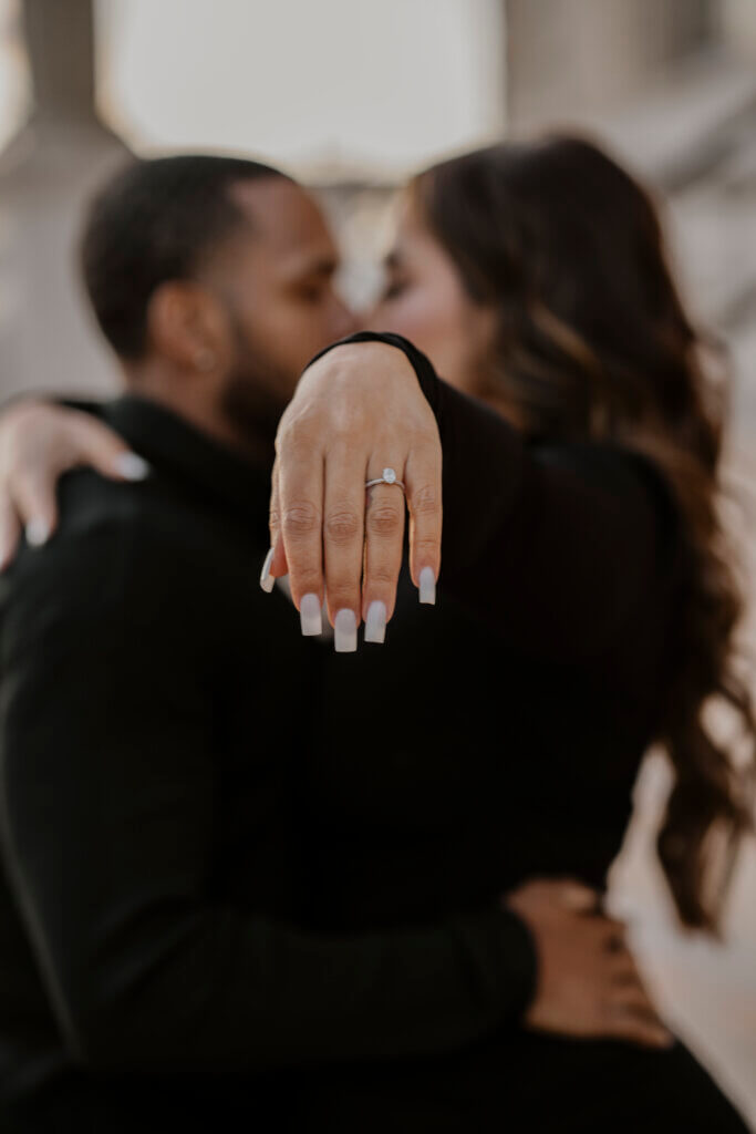 recently engaged Bakersfield couple showing off engagement ring in a ring selfie during their engagement photo session